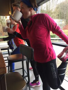 Runners stretching, drinking coffee